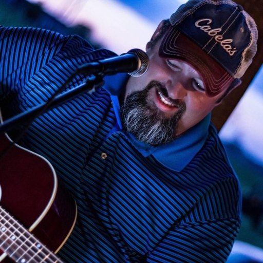 Michael Snowden singing with his guitar